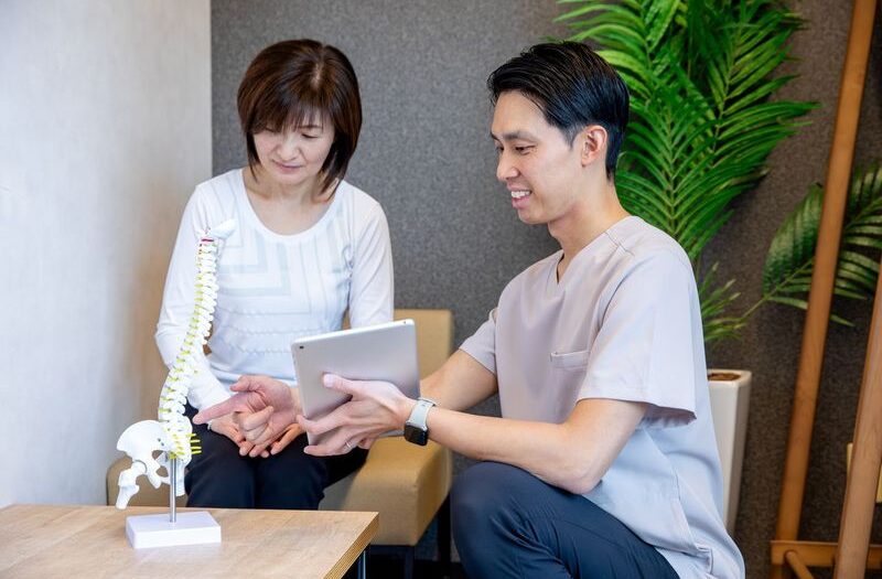 骨盤の模型を指さしながらフィードバックをする男性