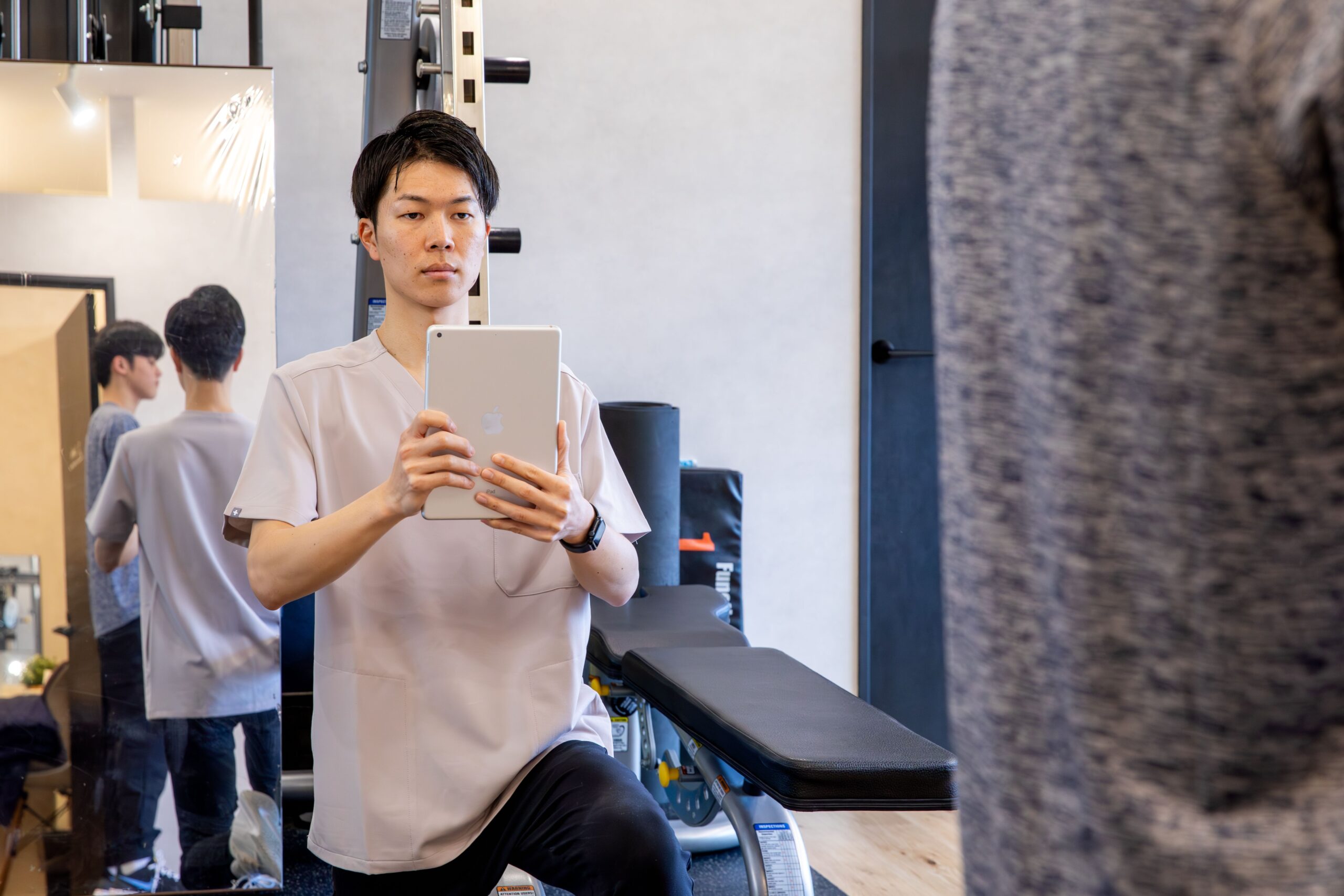 タブレットで写真を撮影するトレーナー